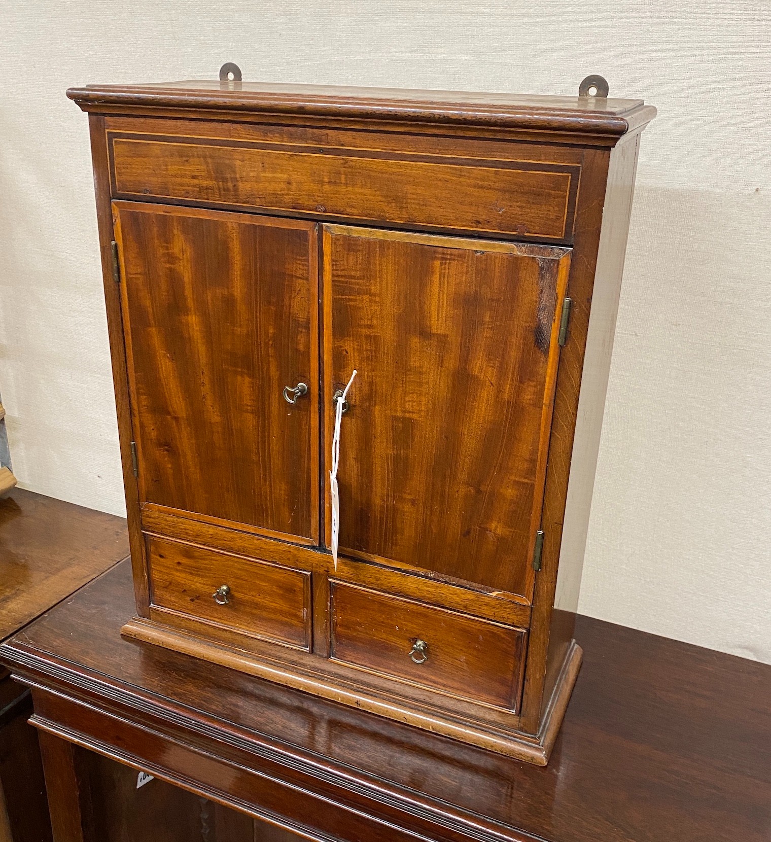 A George III style banded mahogany wall hanging medicine chest, width 39cm, depth 15cm, height 48cm